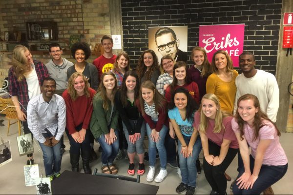 Faculty and students pose for a group photo after volunteering at Erikshjälpen Second Hand.