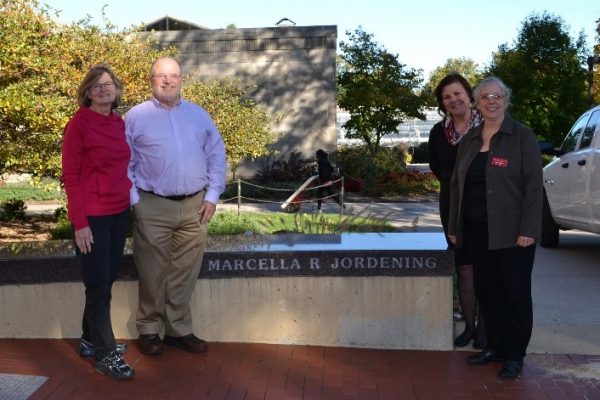 From left to right: Kathy Wiederin, Steven Jordening, Dianne Bystrom and Amy Slagell with the bench honoring Jordening's mother, Marcella Jordening.