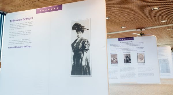 Panels from the "Toward a Universal Suffrage" traveling museum exhibit on display in the Scheman Building. The visible portions of the panels show photos of several African American suffragists from Iowa.